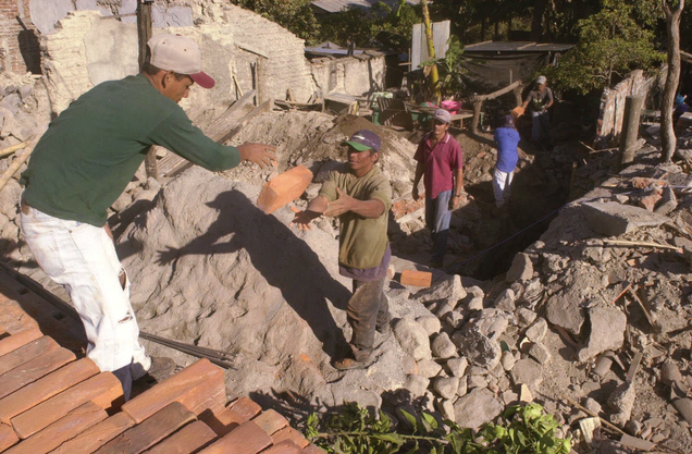 Residents unload bricks as they prepare to reconstruct a home destroyed by the second earthquake that hit El Salvador in 2001. Photo: AP